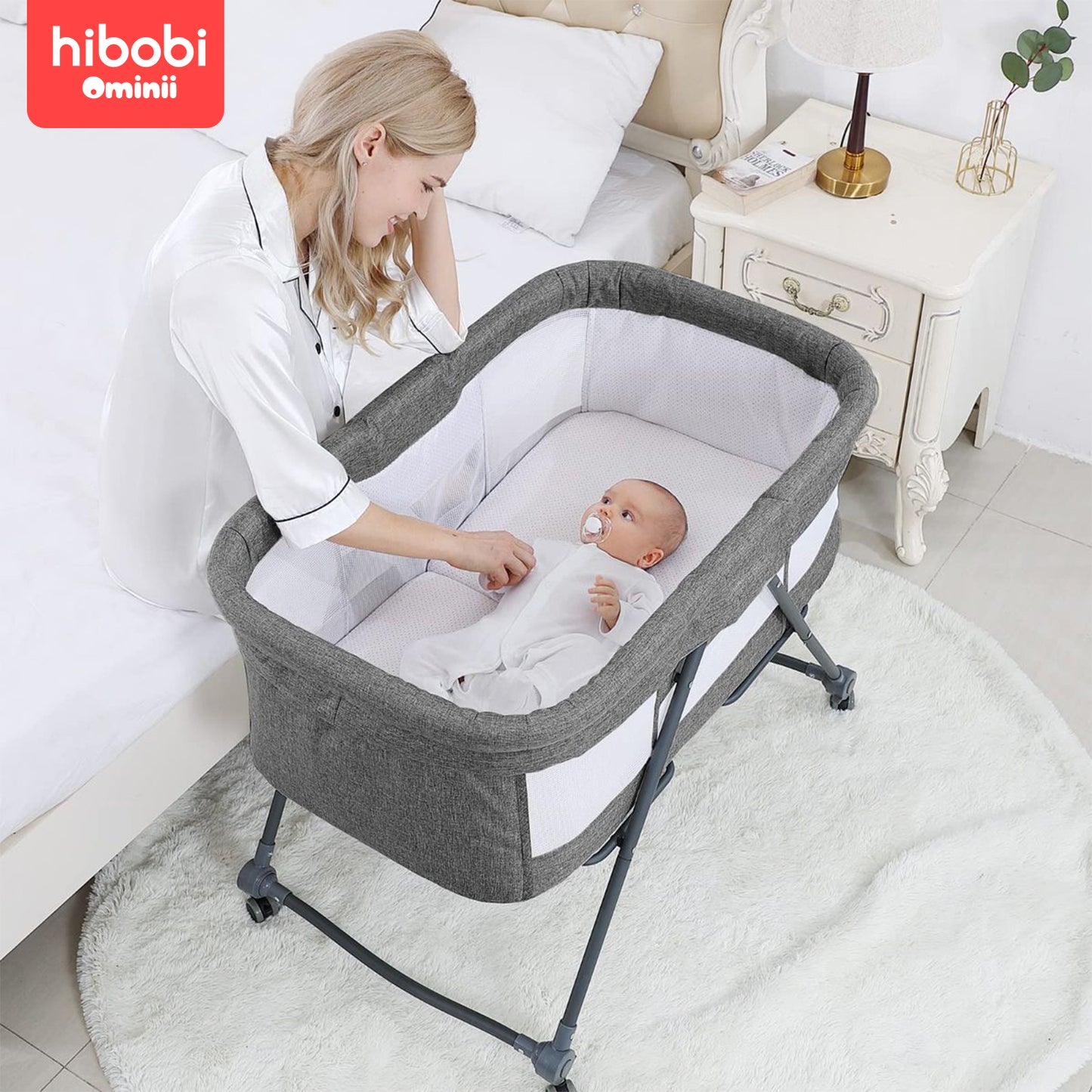 Hibobi Ominni Baby Side Bed, Newborn Foldable Bed, Crib with Large Storage Basket, Portable Infant Bed with Side Net for Travel, Adjustable High with Soft Mattress, Swivel Wheels and Anti-Mosquito Net.